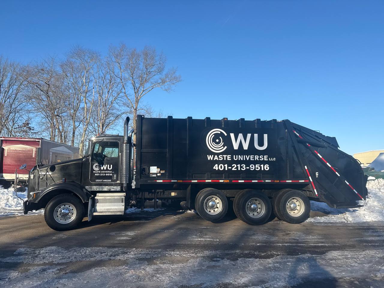 Waste Universe truck with company logo and phone number